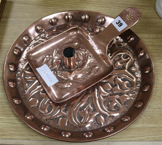 A Newlyn copper candle holder and a similar tray